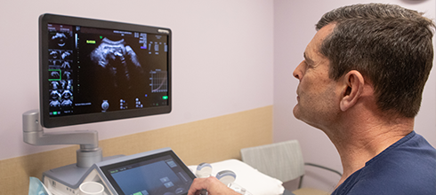 A fetal care specialist reviews a sonogram A fetal care specialist reviews a sonogram